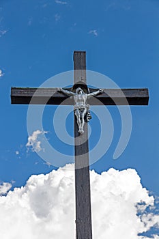 Wooden christian cross in the background of blue sky