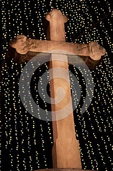 Wooden Christian Cross with Christmas lights and the night sky