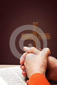 Wooden Christian cross hand next on holy Bible