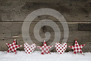 Wooden christmas background with red white checked hearts and st