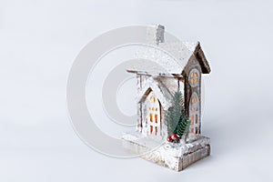 A wooden christmas house with warm light inside. Christmas wooden eco decor. Santa`s house with diodes