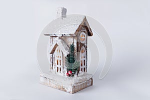 A wooden christmas house with warm light inside. Christmas wooden eco decor. Santa`s house with diodes