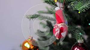 Wooden Christmas Santa toy hanging on artificial Christmas tree