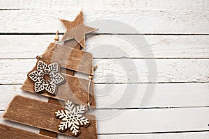 Wooden christmas tree with snowflakes on white background, copy space. happy new year