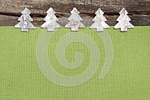 Wooden Christmas trees with green fabric on grey wooden background