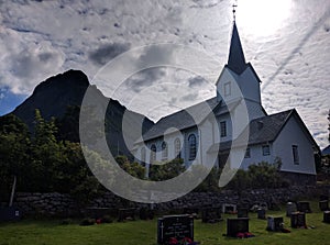 A wooden church with a cemetery in the village of Vartdal in Norway