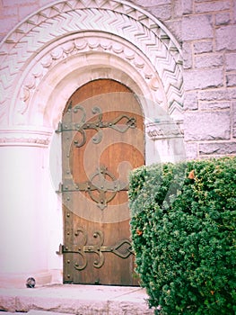 A wooden church door, large hinges,