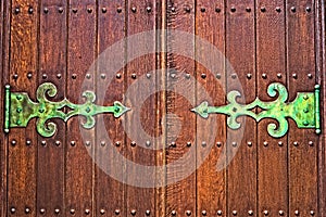 Wooden church doors and ornate hinges