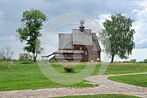 Wooden Church Framed by Trees Under Gray Clouds