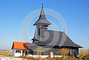 Wooden church on large field photo