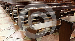 wooden Church pew bench with kneeler inside a Christian church