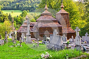 Wooden church of Saint Michael the Archangel in Prikra during summer with the cemetery