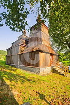 Wooden church of Saint Michael the Archangel in Prikra during summer sunset