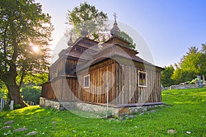 Wooden church of Saint Michael the Archangel in Prikra during summer sunset