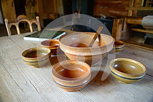 Wooden and clay dinnerware on and old wooden table