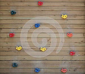 Wooden climbing wall. Colorful plastic parts. For kids