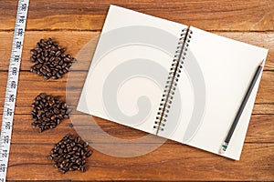 Wooden Clipboard attach planning paper with pencil beside coffee