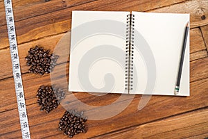 Wooden Clipboard attach planning paper with pencil beside coffee