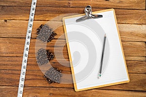 Wooden Clipboard attach planning paper with pencil beside coffee