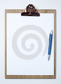 Wooden clipboard with white sheet on