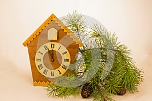 Wooden clock show the time at five minutes to twelve