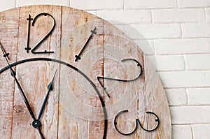 Wooden clockface on white wall