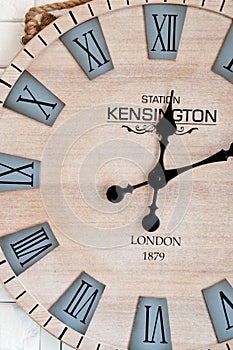 Wooden clockface on white wall