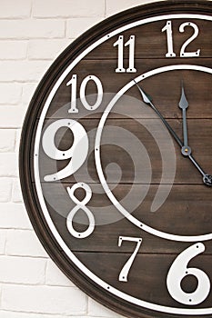 Wooden clockface on white wall