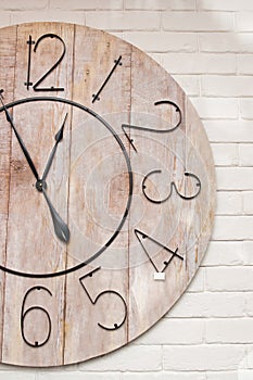 Wooden clockface on white wall