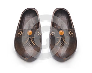 Wooden clogs with amber decoration isolated