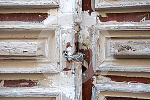 Wooden closed door background, texture. Empty peeled board plank with chain and padlock. Copy space