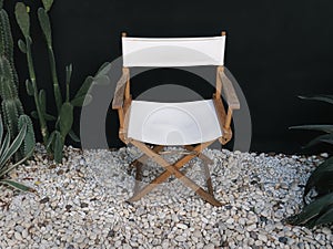 Wooden and Cloth Collapsible Chair on White Pebble Stones