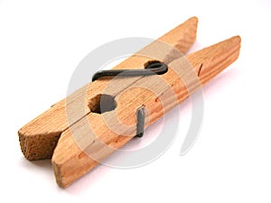 Wooden clothes peg on a white