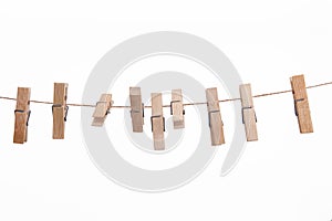 Wooden clothes pegs isolated on a white background.