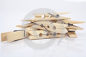 Wooden clothes pegs on a white background.