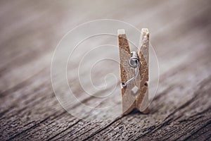 Wooden clothespin on vintage rustic background. The beauty of simple wooden clothespins. Environmentally friendly materials