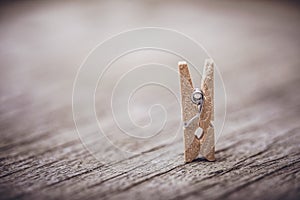 Wooden clothespin on vintage rustic background. The beauty of simple wooden clothespins. Environmentally friendly materials