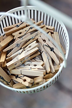 Wooden clothespins in the basket, blur, bright photo. The concept of eco-consumption, the use of natural materials, awareness