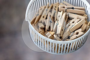 Wooden clothespins in the basket, blur, bright photo. The concept of eco-consumption, the use of natural materials, awareness