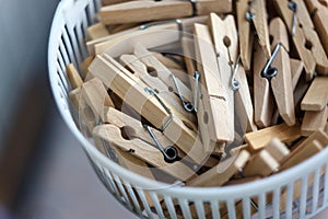 Wooden clothespins in the basket, blur, bright photo. The concept of eco-consumption, the use of natural materials, awareness