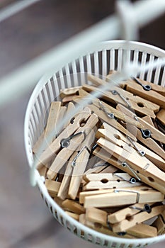 Wooden clothespins in the basket, blur, bright photo. The concept of eco-consumption, the use of natural materials, awareness