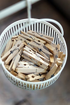 Wooden clothespins in the basket, blur, bright photo. The concept of eco-consumption, the use of natural materials, awareness