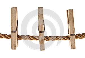 Wooden clothespins on a rope isolated on white background