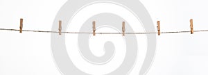 wooden clothespins on a rope on a white background isolate