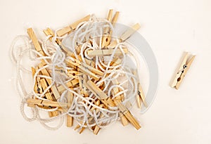 Wooden clothespins on a white rope.