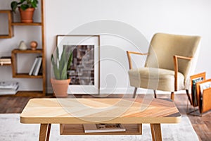 Wooden coffee table in elegant living room interior, real photo photo