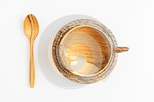 Wooden coffee or tea cup with wooden spoon in top view, isolated