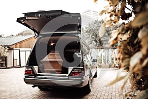 wooden coffin in the back of a car at the crematory