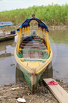 Wooden color canoe in river port