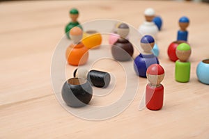 Wooden colorful dolls shaped building blocks on table, closeup. Montessori toy